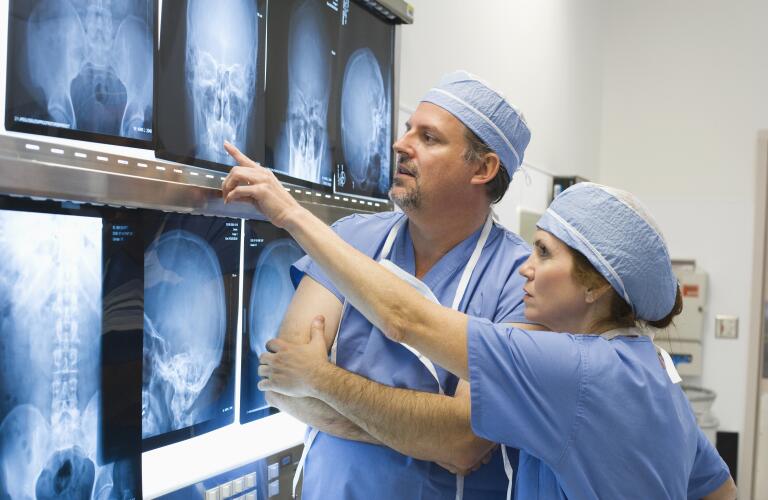 Doctors reviewing x-rays of head in hospital