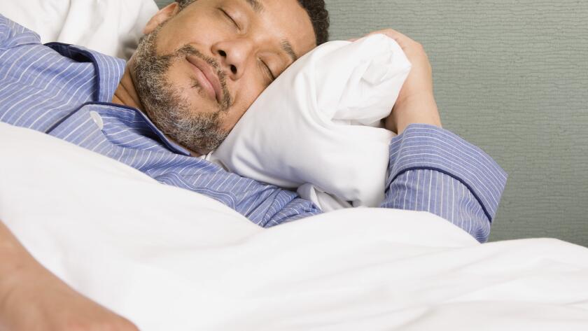 man with beard sleeping in bed