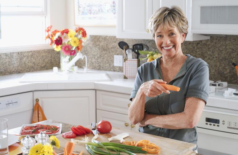 older woman smiling in the kitchen