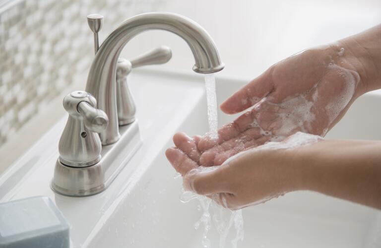 Close-up of woman washing hands
