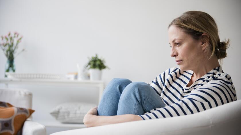 concerned woman sitting in chair