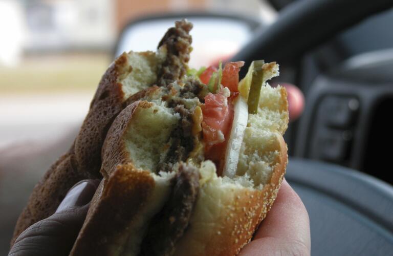 eating burger while driving