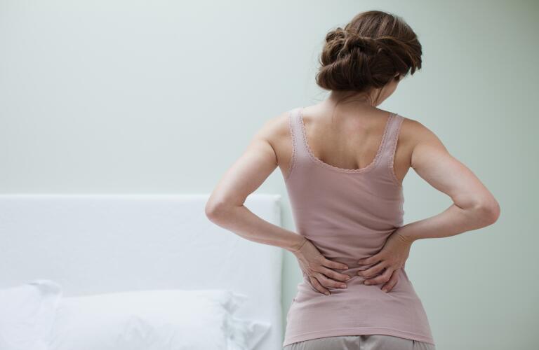 woman-in-bedroom-with-back-pain