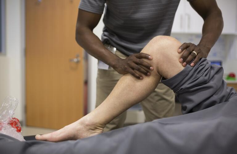 physical-therapist-stretching-patients-leg