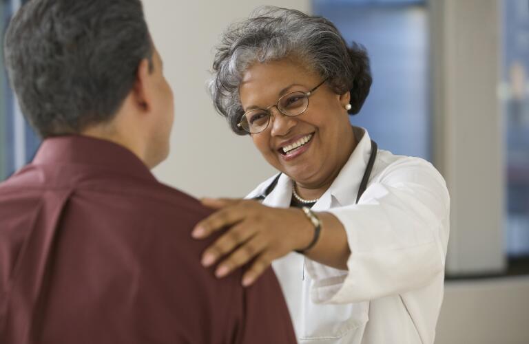 Friendly doctor with patient
