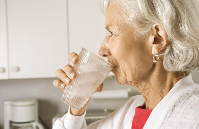 Senior woman drinking water