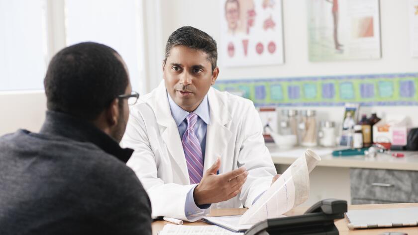 Doctor talking to patient in doctor's office