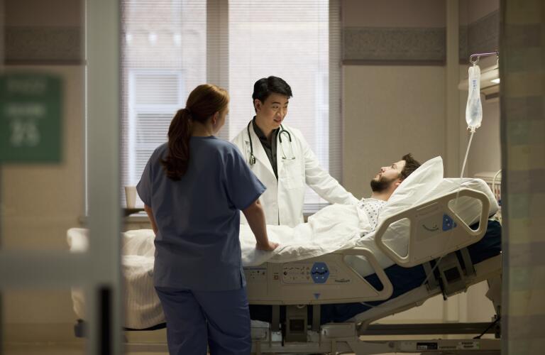 Doctor and nurse talking to patient in hospital