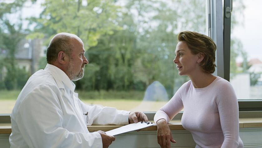 female-patient-talking-with-male-doctor