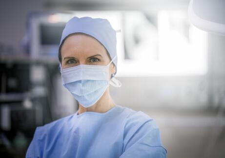 Female doctor wearing blue protective scrubs