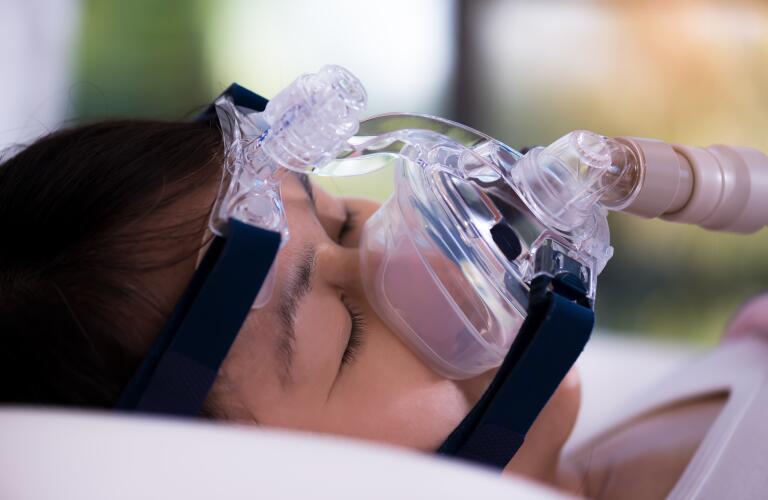 sleeping woman wearing sleep apnea mask