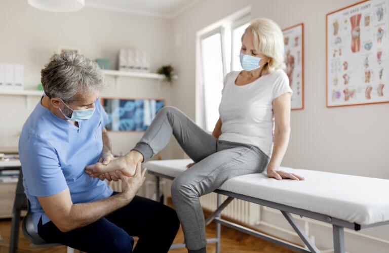 Doctor examining woman's foot