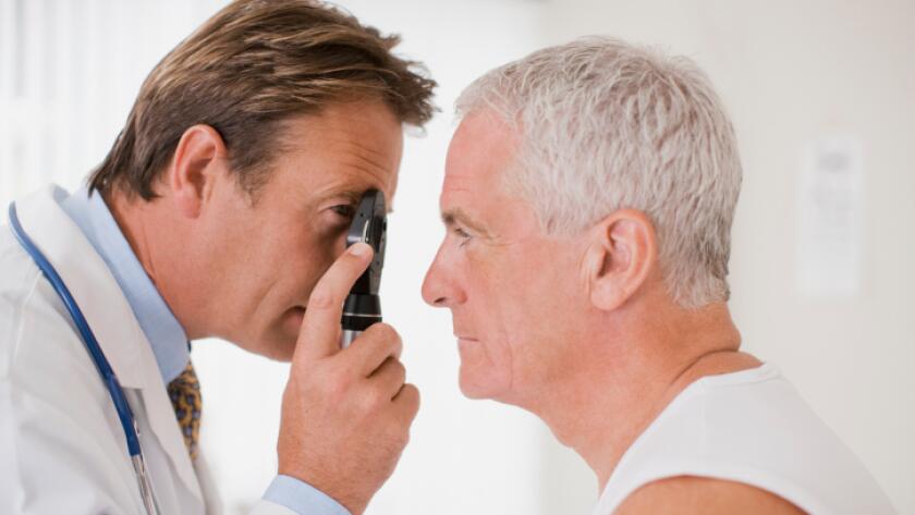 Doctor examining patients eyes