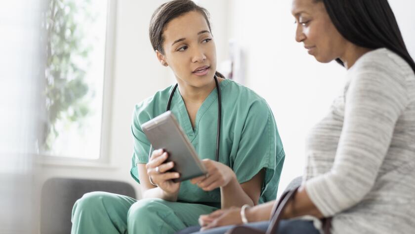 Nurse and patient using digital tablet