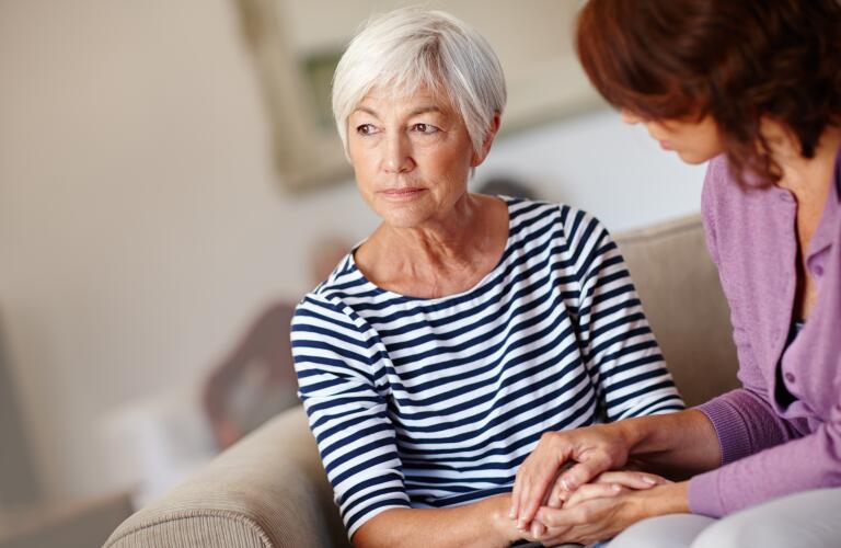 senior woman holding hands of caregiver