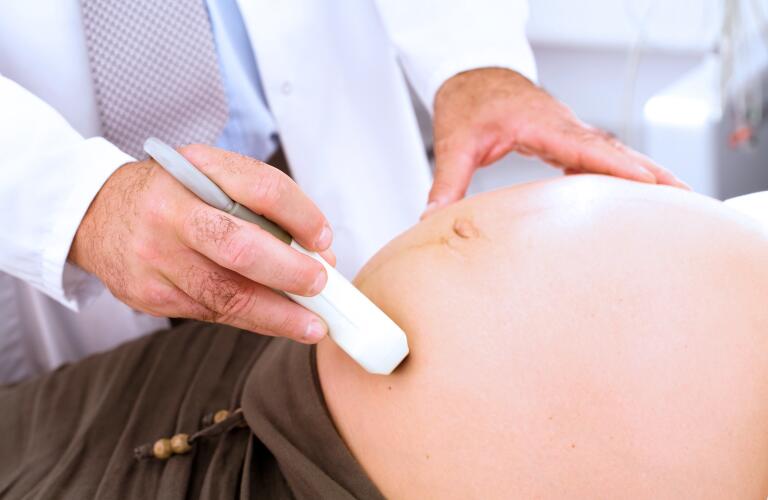 Obstetrician examining pregnant woman