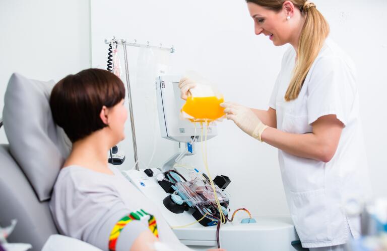 Nurse showing patient donating blood her own blood plasma
