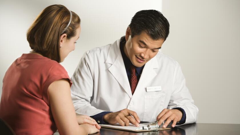 Male doctor consulting with female doctor