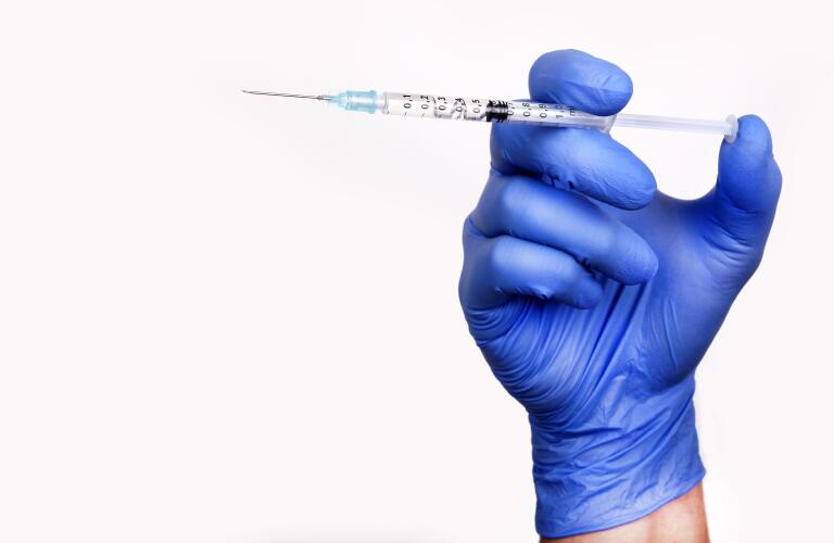 syringe-in-gloved-hand