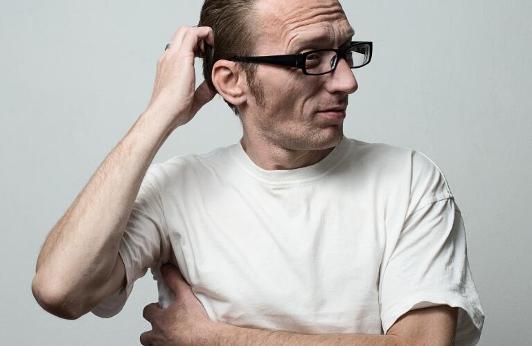 man-scratching-head-and-side