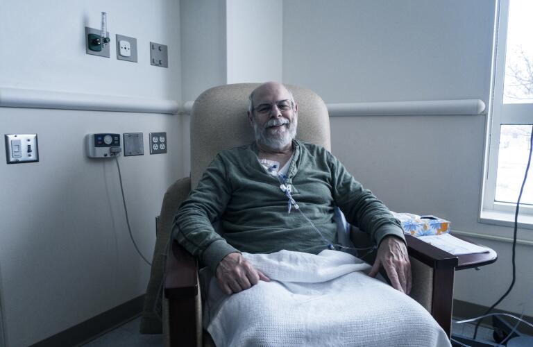 Older Caucasian man receiving chemotherapy treatment