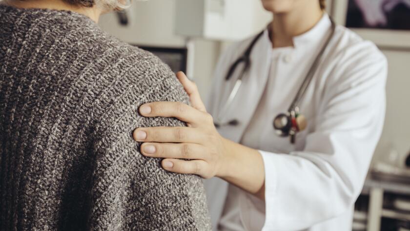doctor with hand on patient's shoulder