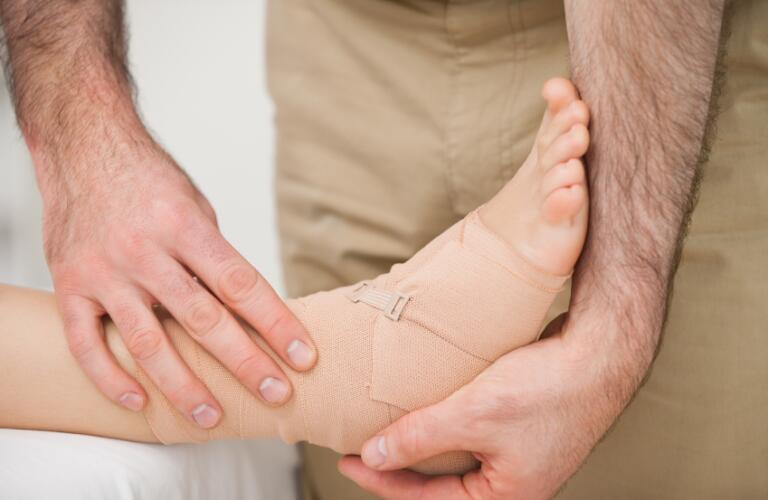 doctor holding foot with wrap
