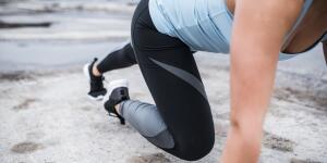 Athletic woman doing mountain climbers outdoors