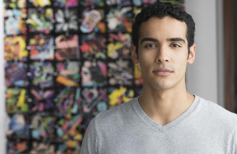 serious Hispanic male in art studio