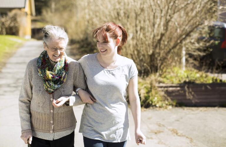 young female caregiver with senior patient