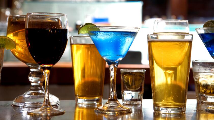 mixture of wine, liquor, beer glasses on bar