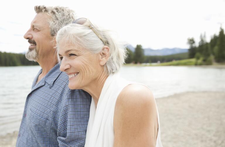 senior-couple-walking-by-water