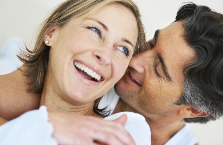 middle aged couple in bed