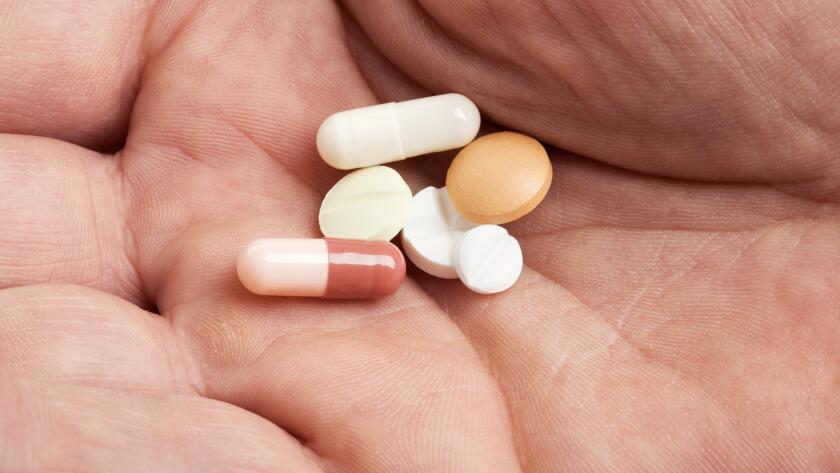 variety-of-pills-in-hand