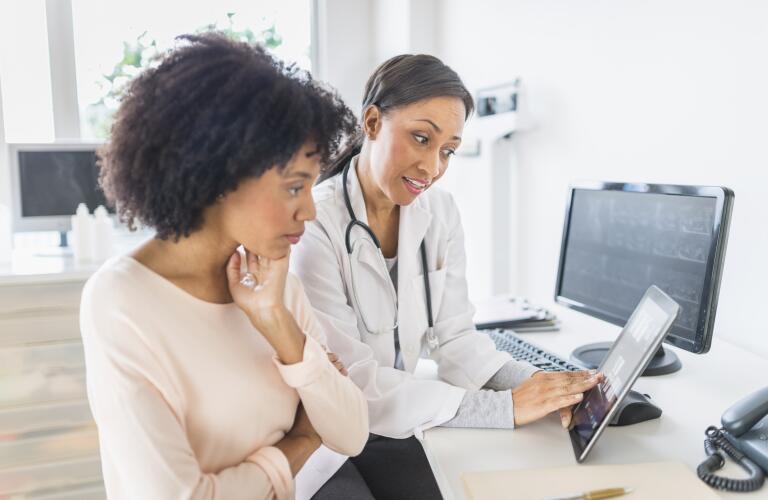 doctor talking to patient and pointing to screen