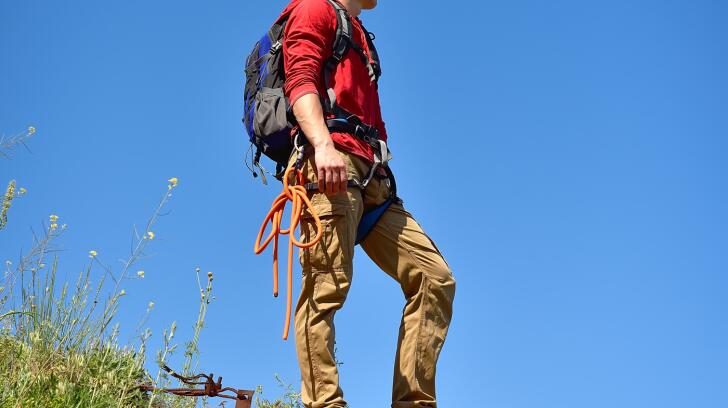 young-male-on-top-of-rock-on-a-blue-sky-background