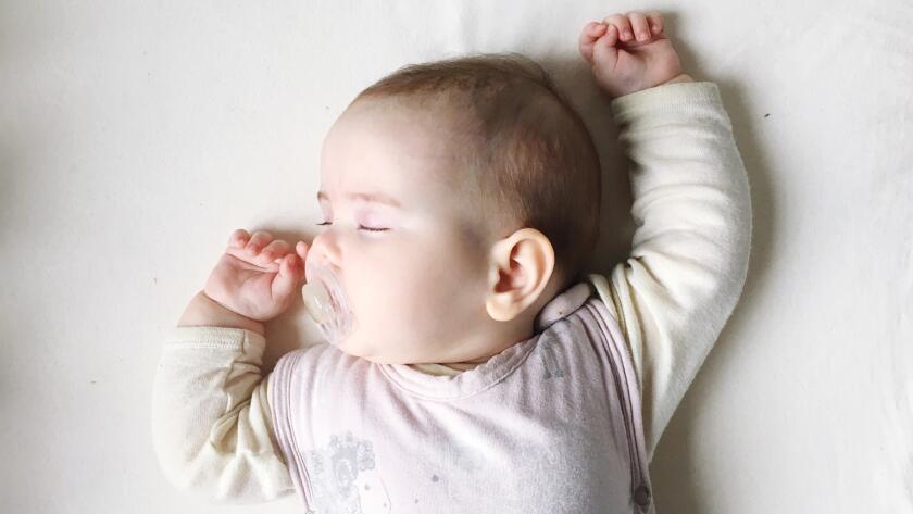 sleeping infant with pacifier