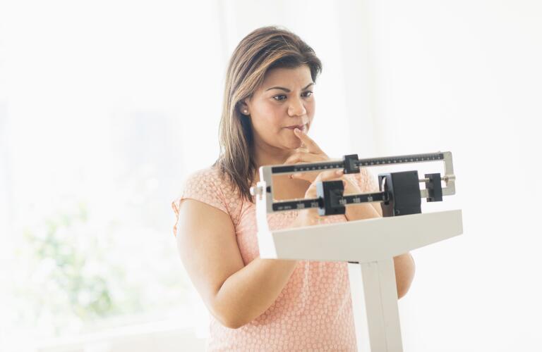 woman-standing-on-weight-scale