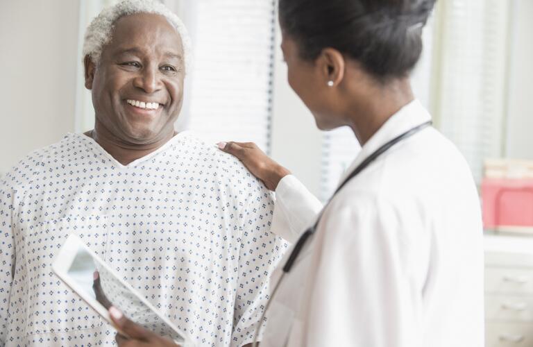 Doctor comforting older man