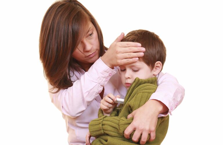 mother checking child's temperature