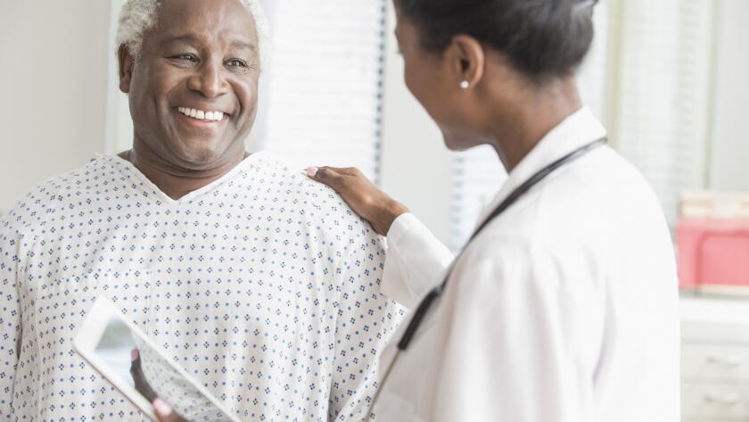 Doctor comforting older man