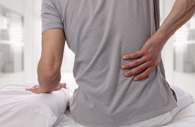 man in bed with back pain