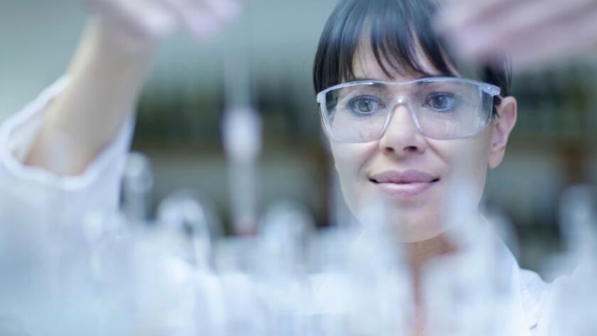 Oenologist mixing during sample testing in laboratory