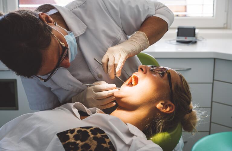 Young female Caucasian patient at dentist getting exam