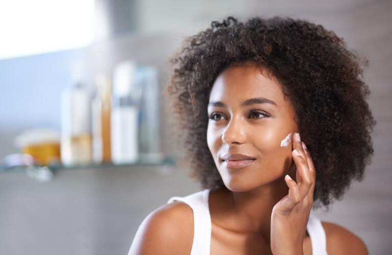 Woman applying skin cream
