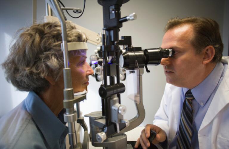 Ophthalmologist checking woman's eyes