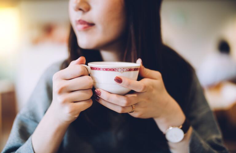 woman holding cup of tea