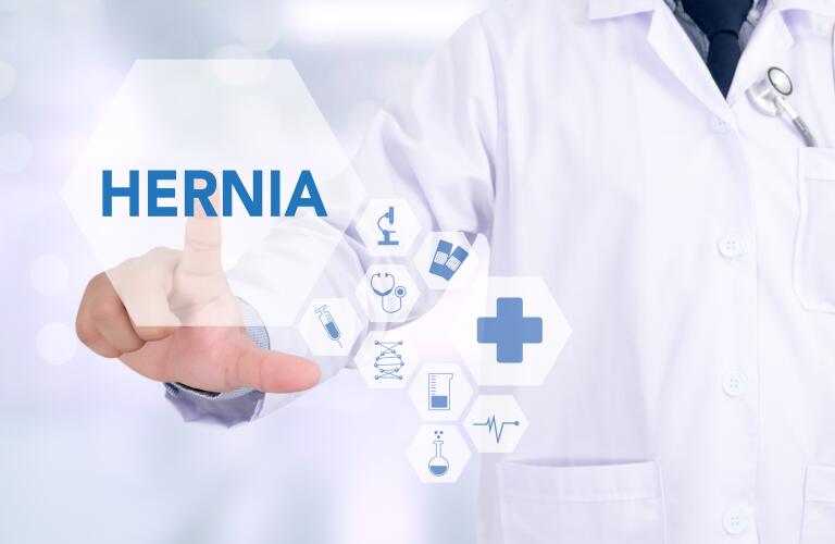 hernia concept image with doctor pointing to the word hernia