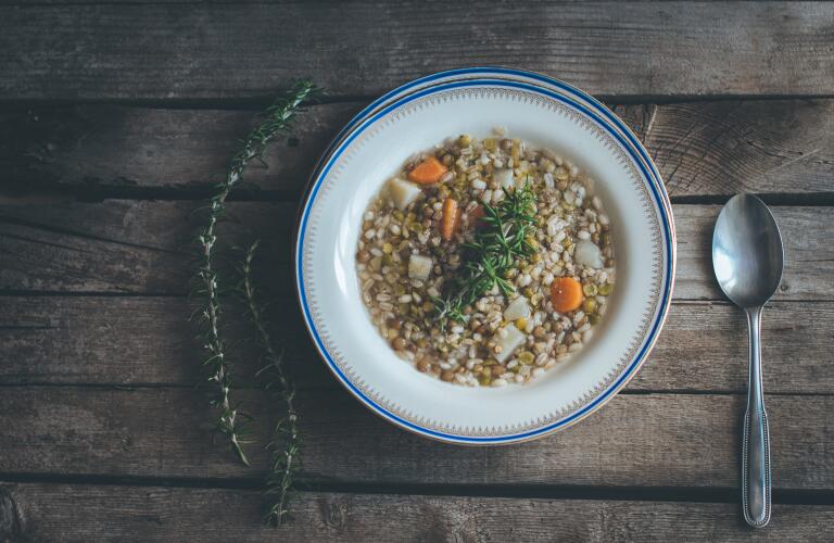bowl of bean and vegetable soup on table