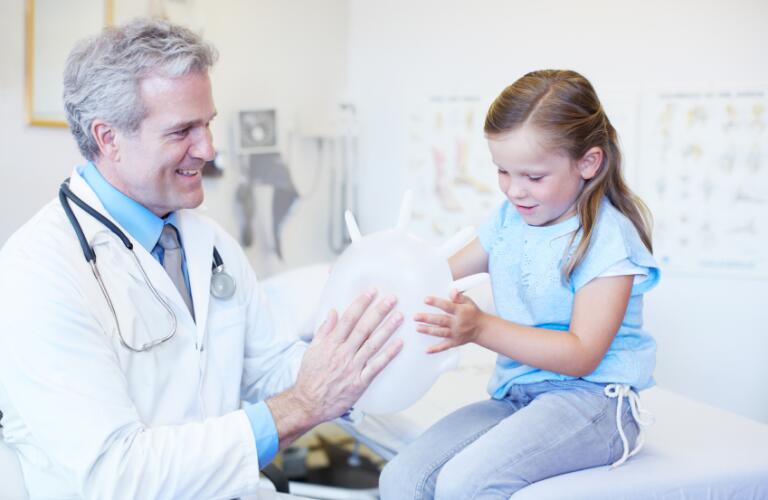 Male doctor with young child
